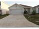 Charming single-story home featuring a well-manicured lawn and a spacious two-car garage at 1668 Hazy Sea Dr, Plant City, FL 33565