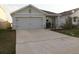 Charming single-story home featuring a well-manicured lawn and a spacious two-car garage at 1668 Hazy Sea Dr, Plant City, FL 33565
