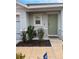 Inviting front porch with landscaping and a light-colored front door at 1668 Hazy Sea Dr, Plant City, FL 33565
