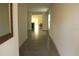 Tiled hallway with a decorative mirror that leads to a bright living area at 1668 Hazy Sea Dr, Plant City, FL 33565