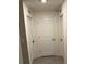 Bright hallway with three doors and tile floor at 1668 Hazy Sea Dr, Plant City, FL 33565