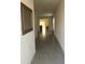 Tiled hallway with a decorative mirror that leads to a bright living area at 1668 Hazy Sea Dr, Plant City, FL 33565