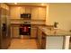 Modern kitchen with stainless steel appliances and countertops, and tiled floor at 1668 Hazy Sea Dr, Plant City, FL 33565