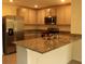 Modern kitchen with stainless steel appliances and countertops, and tiled floor at 1668 Hazy Sea Dr, Plant City, FL 33565