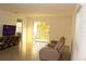 Open-concept living room with tile flooring, a comfortable sofa and sliding glass door at 1668 Hazy Sea Dr, Plant City, FL 33565
