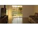Open-concept living room with tile flooring, a comfortable sofa and sliding glass door at 1668 Hazy Sea Dr, Plant City, FL 33565
