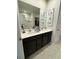 Double vanity bathroom with dark brown cabinets and large mirror at 178 Brofield St, Brooksville, FL 34604