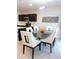 Modern dining area with glass table and white chairs at 178 Brofield St, Brooksville, FL 34604