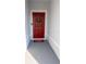 Front entry with red door, wreath, and welcome mat at 178 Brofield St, Brooksville, FL 34604