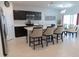 Modern kitchen with island, breakfast bar, and stainless steel appliances at 178 Brofield St, Brooksville, FL 34604
