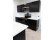 Modern kitchen with dark cabinetry and stainless steel appliances at 178 Brofield St, Brooksville, FL 34604