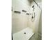 Clean shower with tiled walls and multiple shelves at 178 Brofield St, Brooksville, FL 34604