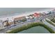 Aerial of beachfront property with ocean, road, and buildings at 18838 Gulf Blvd # 202, Indian Shores, FL 33785