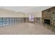 Unfinished basement with tiled floor and stone fireplace at 18838 Gulf Blvd # 202, Indian Shores, FL 33785