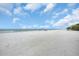 Expansive beachfront view with white sand and clear sky at 18838 Gulf Blvd # 202, Indian Shores, FL 33785