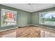 Bedroom with two windows, hardwood floors and ceiling fan at 18838 Gulf Blvd # 202, Indian Shores, FL 33785