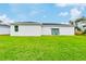 Grass lawn behind a white house with patio furniture at 189 Statler St, Port Charlotte, FL 33954