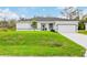 White house with gray roof and a nicely landscaped yard at 189 Statler St, Port Charlotte, FL 33954