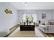 Bright living room with large windows, wooden coffee table, and comfy seating at 189 Statler St, Port Charlotte, FL 33954