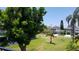 Landscaped backyard with spacious green lawn and neighborhood views at 255 Capri N Cir # 17, Treasure Island, FL 33706