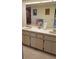 Clean bathroom with double vanity, tile flooring, and large mirror at 255 Capri N Cir # 17, Treasure Island, FL 33706