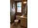 Small bathroom with toilet, sink, and patterned wallpaper at 255 Capri N Cir # 17, Treasure Island, FL 33706