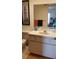 Bathroom with vanity, toilet, and mirror reflecting bedroom at 255 Capri N Cir # 17, Treasure Island, FL 33706