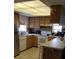 Updated kitchen with wood cabinets, built-in appliances, and a breakfast bar at 255 Capri N Cir # 17, Treasure Island, FL 33706