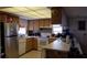 Galley kitchen with light wood cabinets and stainless steel appliances at 255 Capri N Cir # 17, Treasure Island, FL 33706