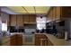 Bright kitchen features wood cabinets, updated appliances, and ample counter space at 255 Capri N Cir # 17, Treasure Island, FL 33706