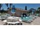 Community pool area with tables, chairs, and lounge chairs at 255 Capri N Cir # 17, Treasure Island, FL 33706