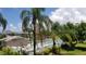 Community pool with surrounding patio furniture and tropical landscaping at 255 Capri N Cir # 17, Treasure Island, FL 33706