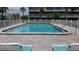 Inviting community swimming pool with lounge chairs at 255 Capri N Cir # 17, Treasure Island, FL 33706