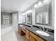 Elegant bathroom with double sinks, granite countertops, and large mirrors at 2712 Mock Orange Ct, Valrico, FL 33594