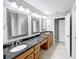 Double vanity bathroom with granite countertops and stylish mirrors at 2712 Mock Orange Ct, Valrico, FL 33594