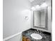Bathroom with granite countertop vanity and decorative mirror at 2712 Mock Orange Ct, Valrico, FL 33594