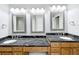Bathroom boasts double sinks, granite countertops, and ornate mirrors at 2712 Mock Orange Ct, Valrico, FL 33594