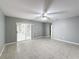 Spacious bedroom with tile floors and sliding glass doors leading to a patio at 2712 Mock Orange Ct, Valrico, FL 33594