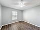 Bright bedroom with wood-look floors and ceiling fan at 2712 Mock Orange Ct, Valrico, FL 33594