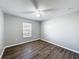 Bright bedroom with wood-look floors and ceiling fan at 2712 Mock Orange Ct, Valrico, FL 33594