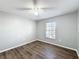 Bright bedroom with wood-look floors and ceiling fan at 2712 Mock Orange Ct, Valrico, FL 33594