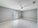 Simple bedroom with tile floors and window with blinds at 2712 Mock Orange Ct, Valrico, FL 33594