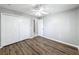 Well-lit bedroom featuring double door closet and wood-look floors at 2712 Mock Orange Ct, Valrico, FL 33594