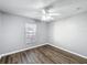Bright bedroom with ceiling fan and wood-look floors at 2712 Mock Orange Ct, Valrico, FL 33594