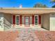 Inviting home exterior featuring a covered entryway, brick walkway, and red shutters at 2712 Mock Orange Ct, Valrico, FL 33594