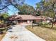 Ranch-style home with red shutters and a spacious driveway at 2712 Mock Orange Ct, Valrico, FL 33594