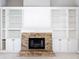 Brick fireplace with built-in white cabinets at 2712 Mock Orange Ct, Valrico, FL 33594