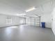 Garage with freshly painted floor, overhead door, and natural light at 2712 Mock Orange Ct, Valrico, FL 33594