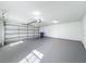 Spacious garage with painted floor, automatic door, and ample storage at 2712 Mock Orange Ct, Valrico, FL 33594