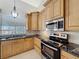 Eat-in kitchen with stainless steel appliances and granite countertops at 2712 Mock Orange Ct, Valrico, FL 33594